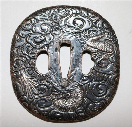 A late 19th/early 20th century Japanese silvered bronze tsuba, 3in.